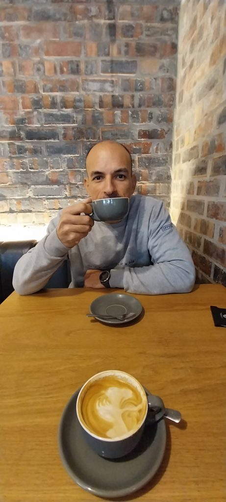 Enjoying a flat white while waiting on breakfast.